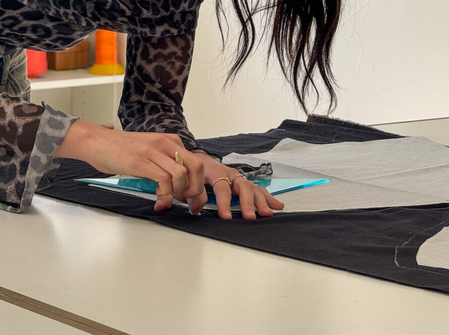 Studiare moda significa esercitarsi sul campo, una razza allieva di IFDA sta tagliando del tessuto per approntare un modello